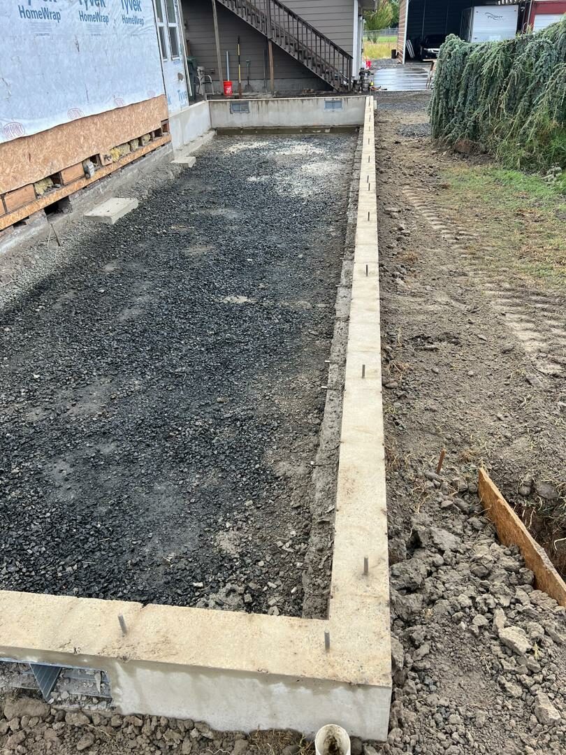 Excavated and framed concrete footing prepared for a home addition and renovation project in Eugene, Oregon.